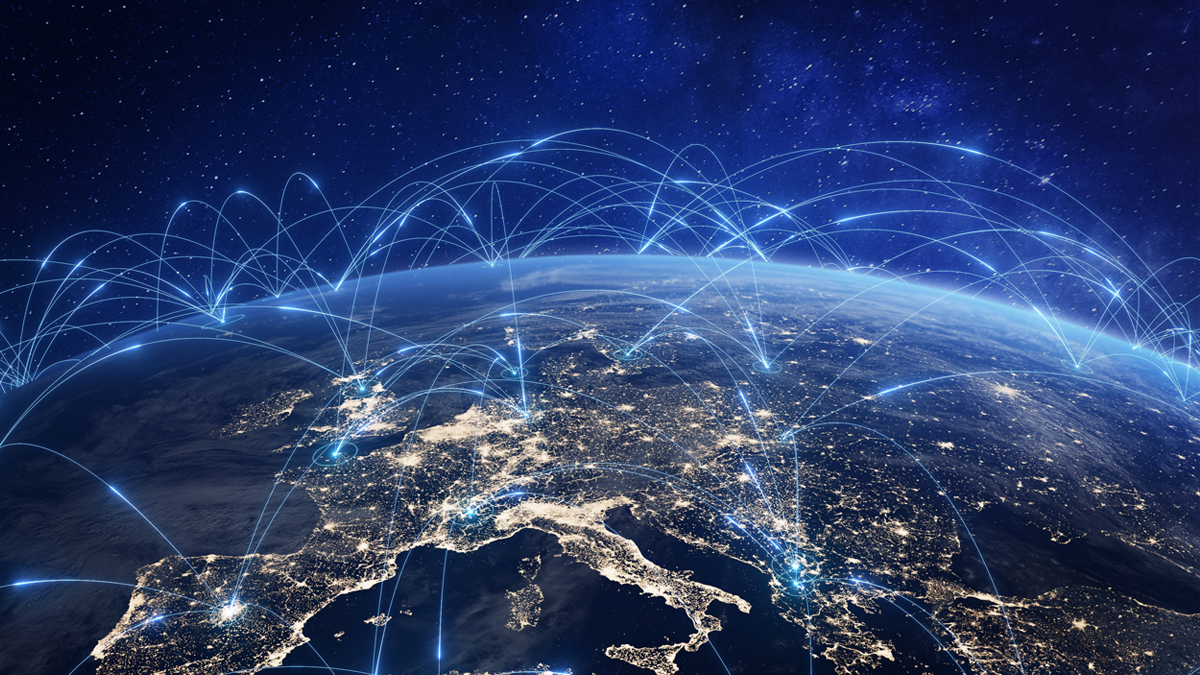 A view of Earth from space at night, showing illuminated cities connected by glowing arcs representing global communication networks.