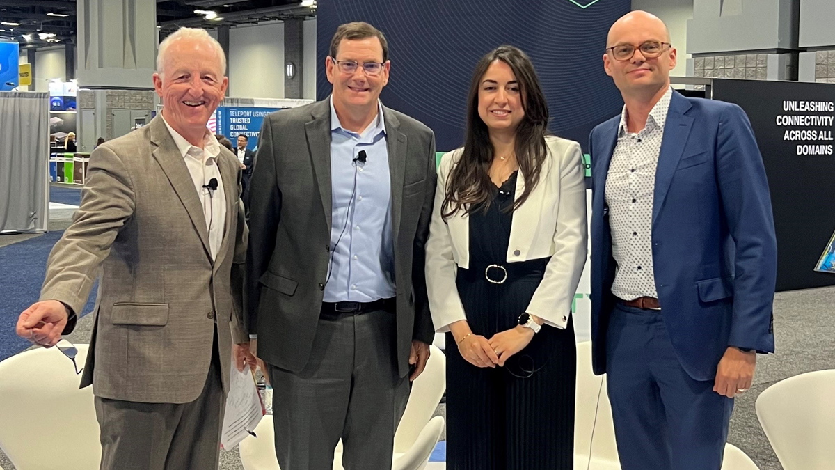 A group of four professionals smiling for a photo at the SATELLITE 2024 conference in Washington, D.C.