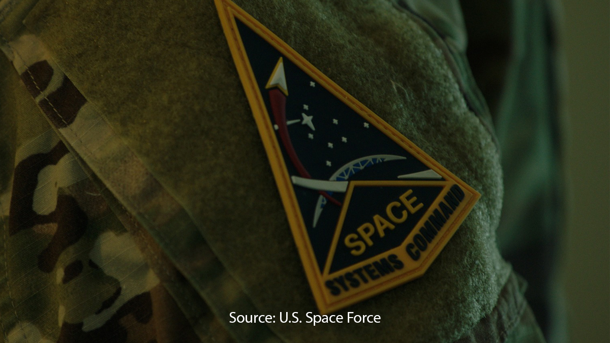 Military uniform featuring a triangular patch with a space-themed design and the words 'Space Systems Command.' (Source: U.S. Space Force)