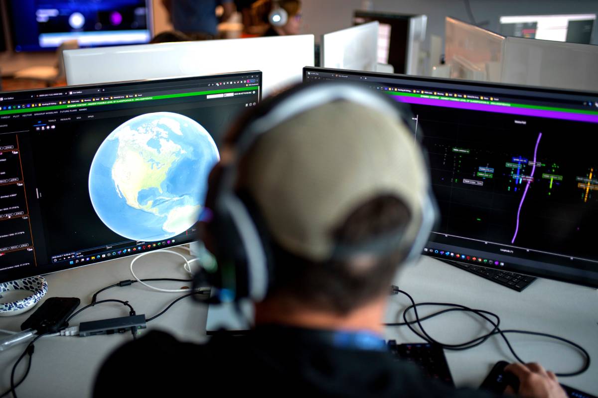 James Kirby, deputy site lead with the Joint Commercial Operations cell, participates in a training cycle while viewing data on computer monitors. (Source: USSF/Tiana Williams)