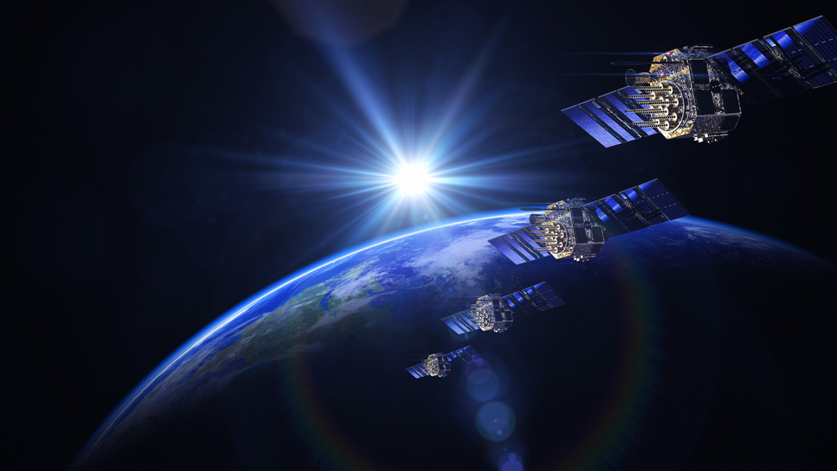 Four satellites orbit Earth with the sun in the background, representing AI-driven space security systems.