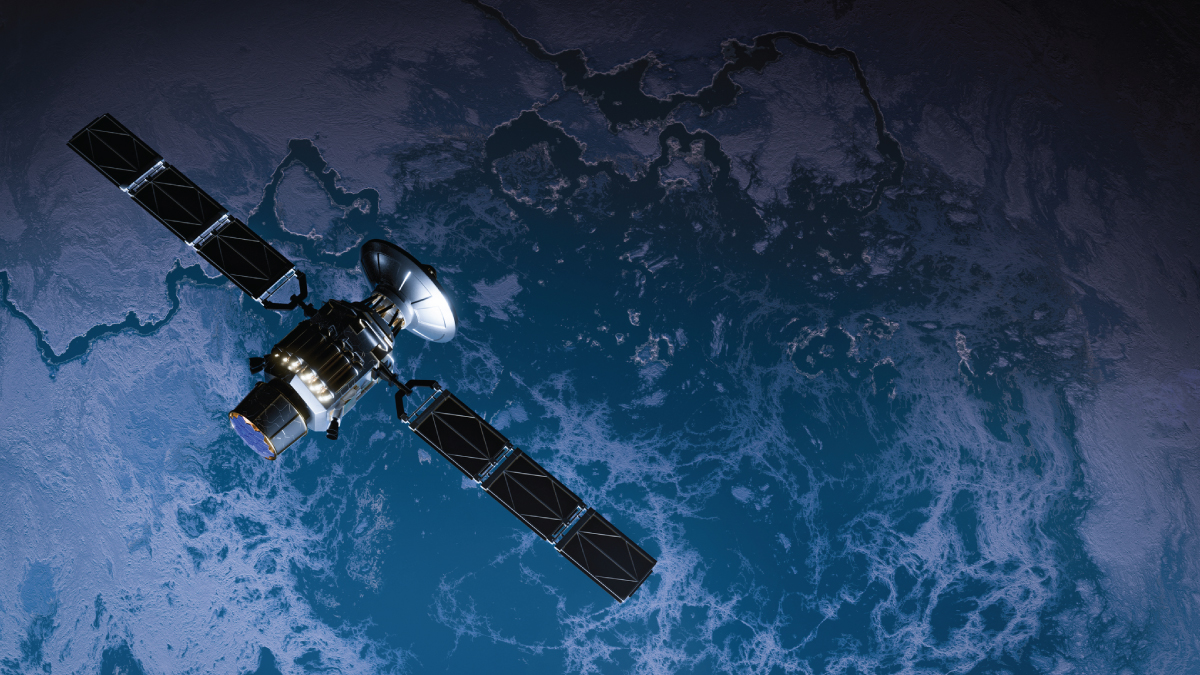 Satellite with a large dish antenna and twin solar arrays orbiting above the curved, sunlit Earth partly covered by clouds.