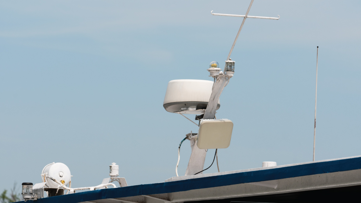 Marine vessel roof with antenna system, featuring radar dome, satellite receiver, and GPS for advanced connectivity.
