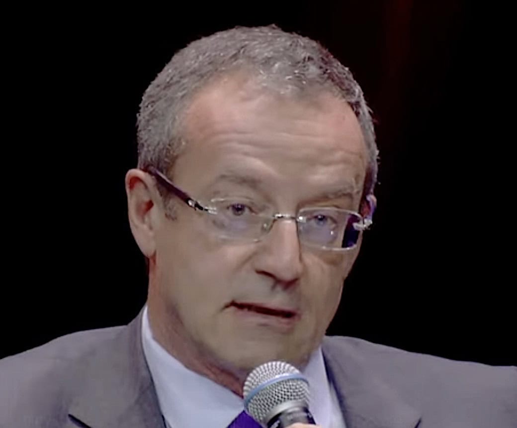 Eutelsat Chief Executive Jean-François Fallacher speaking into a microphone during a conference.