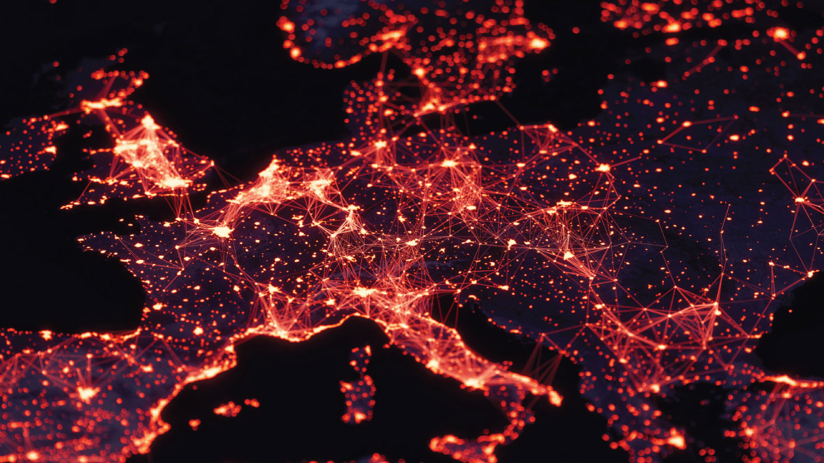Map of Europe at night with glowing red and orange lights representing population centers connected by a digital network.