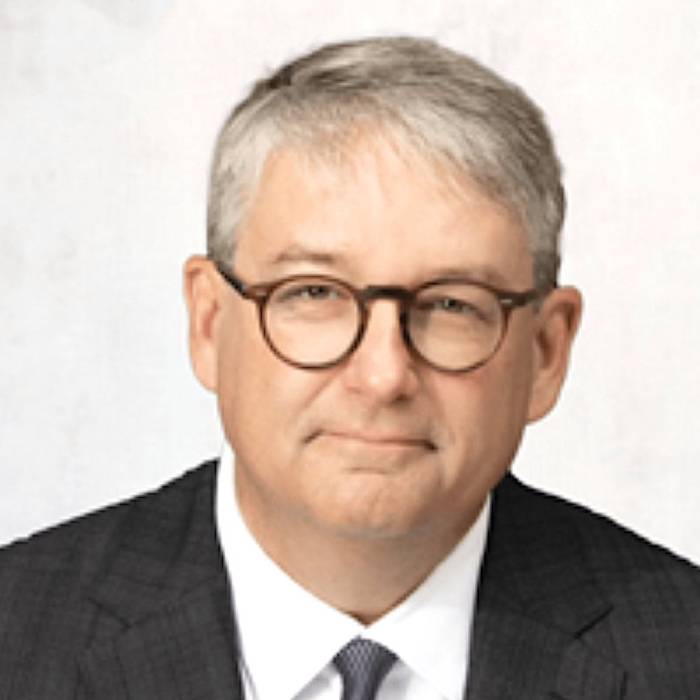 Head-and-shoulders portrait of Barbee Ponder, Globalstar's general counsel, with short gray hair and round eyeglasses wearing a dark checkered suit, white shirt, and dark tie against a plain light background.