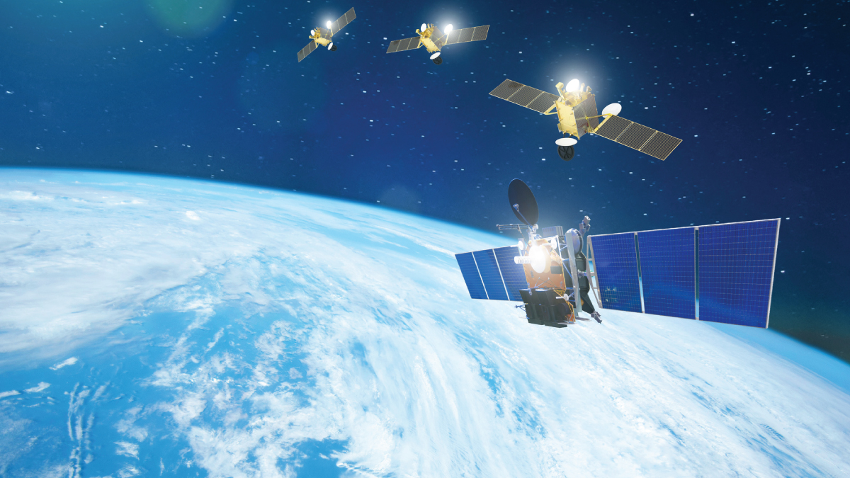 View of Earth from space with four solar‑panelled satellites flying in formation above the blue, cloud‑streaked planet against a star-filled background.