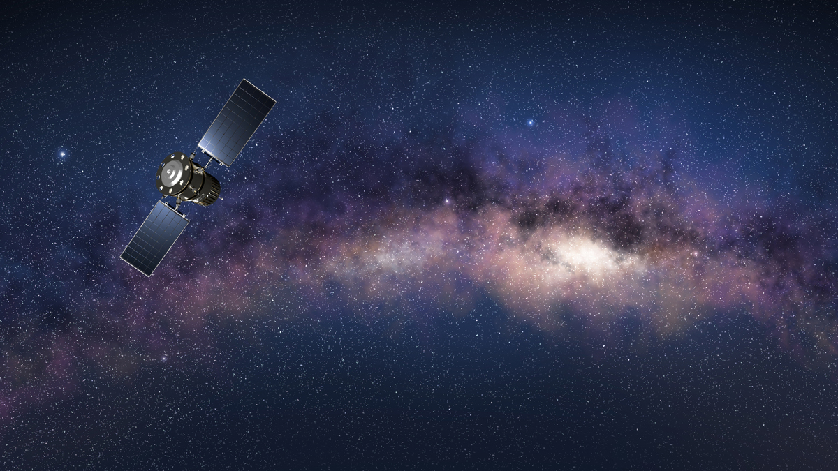 A satellite with extended solar panels orbits against the vibrant, starry backdrop of the Milky Way galaxy.