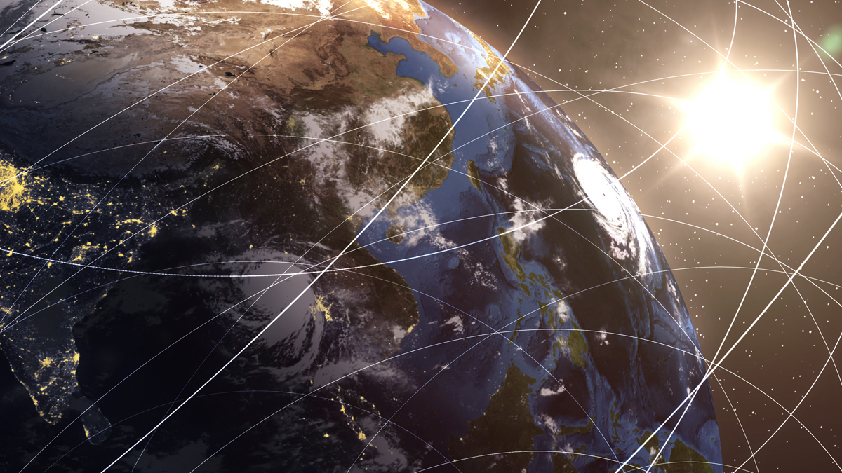 An orbital view of the Earth with crisscrossing white lines depicting data connections and satellite tracks, highlighted by a bright sun in space.