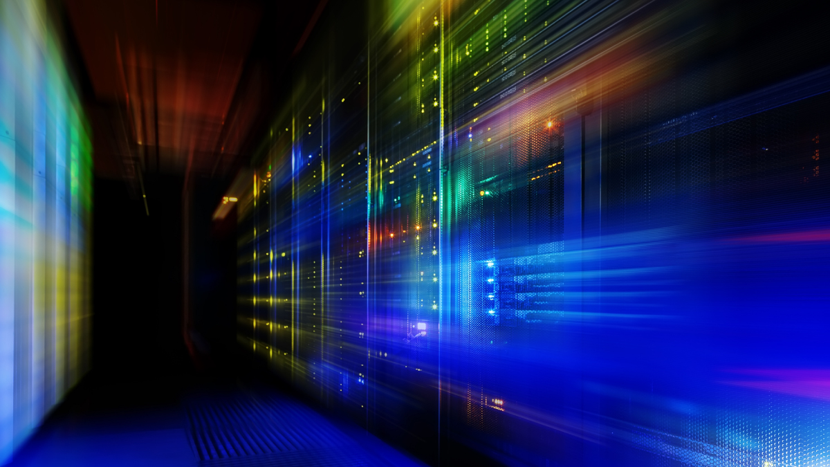 A stylized, futuristic illustration of a data center server room featuring streaks of multicolored light that convey speed and motion.