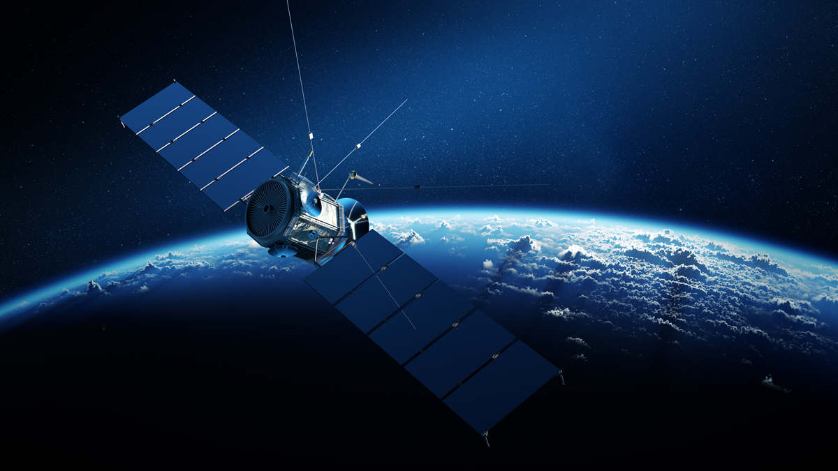 A digital rendering of a satellite with extended solar arrays orbiting high above the Earth's blue, cloud-covered horizon.