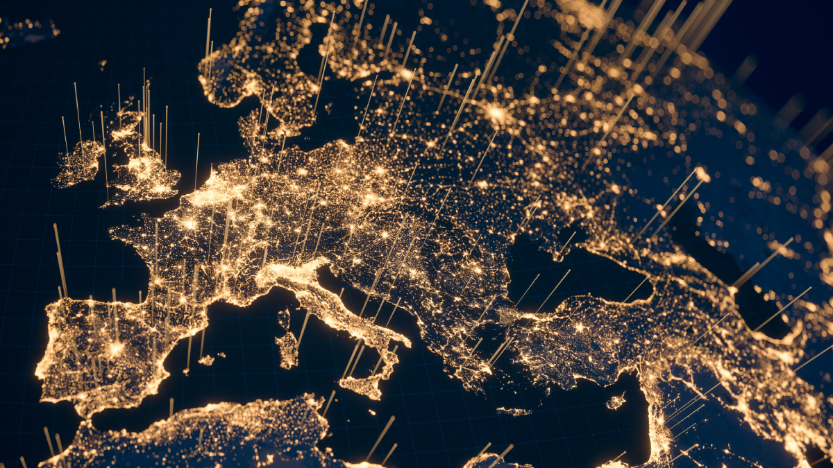 A stylized digital map of Europe at night features glowing golden light clusters and vertical beams representing a space-based communication network.