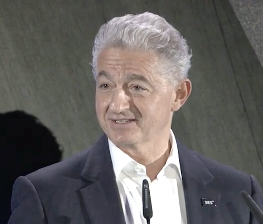 SES CEO Adel Al-Saleh wearing a dark suit and company lapel pin.