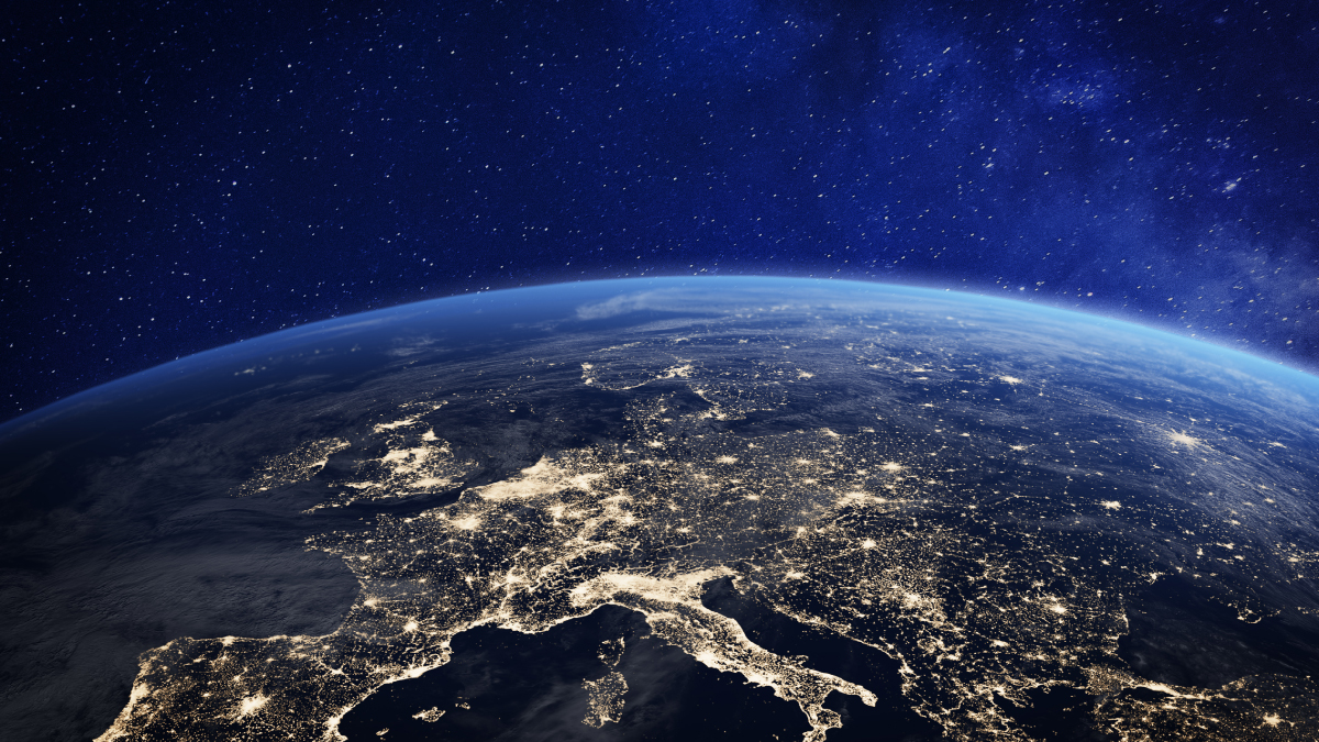 A view of Earth from space at night, showing the illuminated city lights of Europe and the Mediterranean against a starry background.