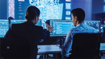 Two people at virtual ground workstations analyzing results.