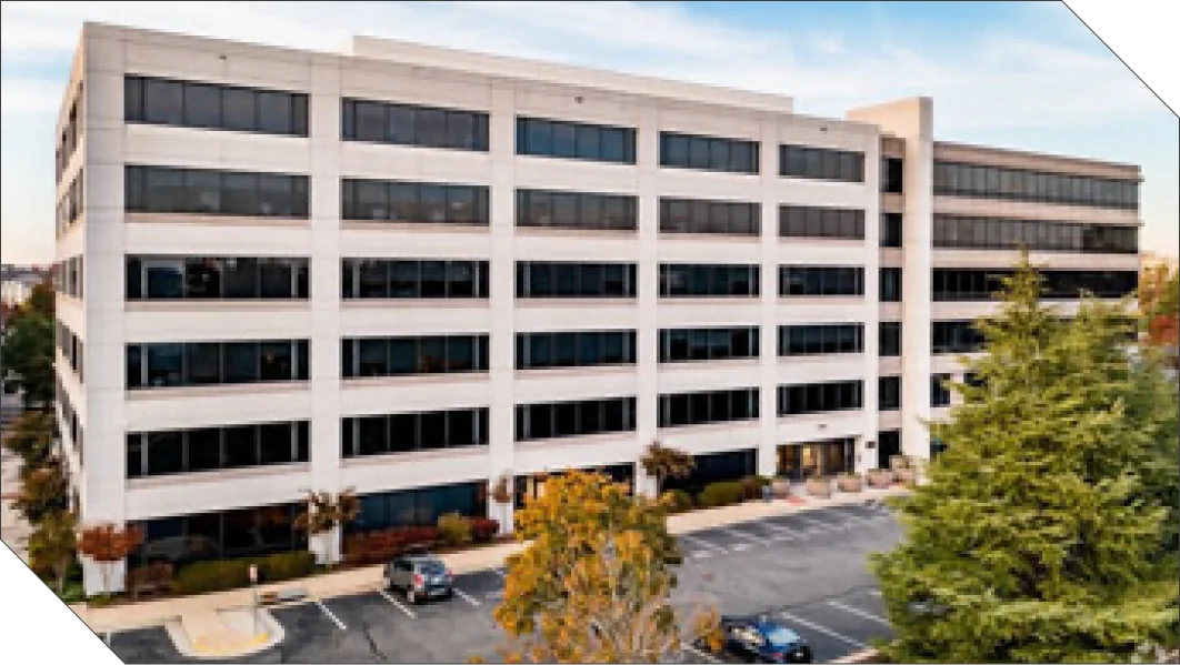 Modern architectural structure of Kratos Space Headquarters at Herndon, Virginia, featured on a clean geometric background frame.