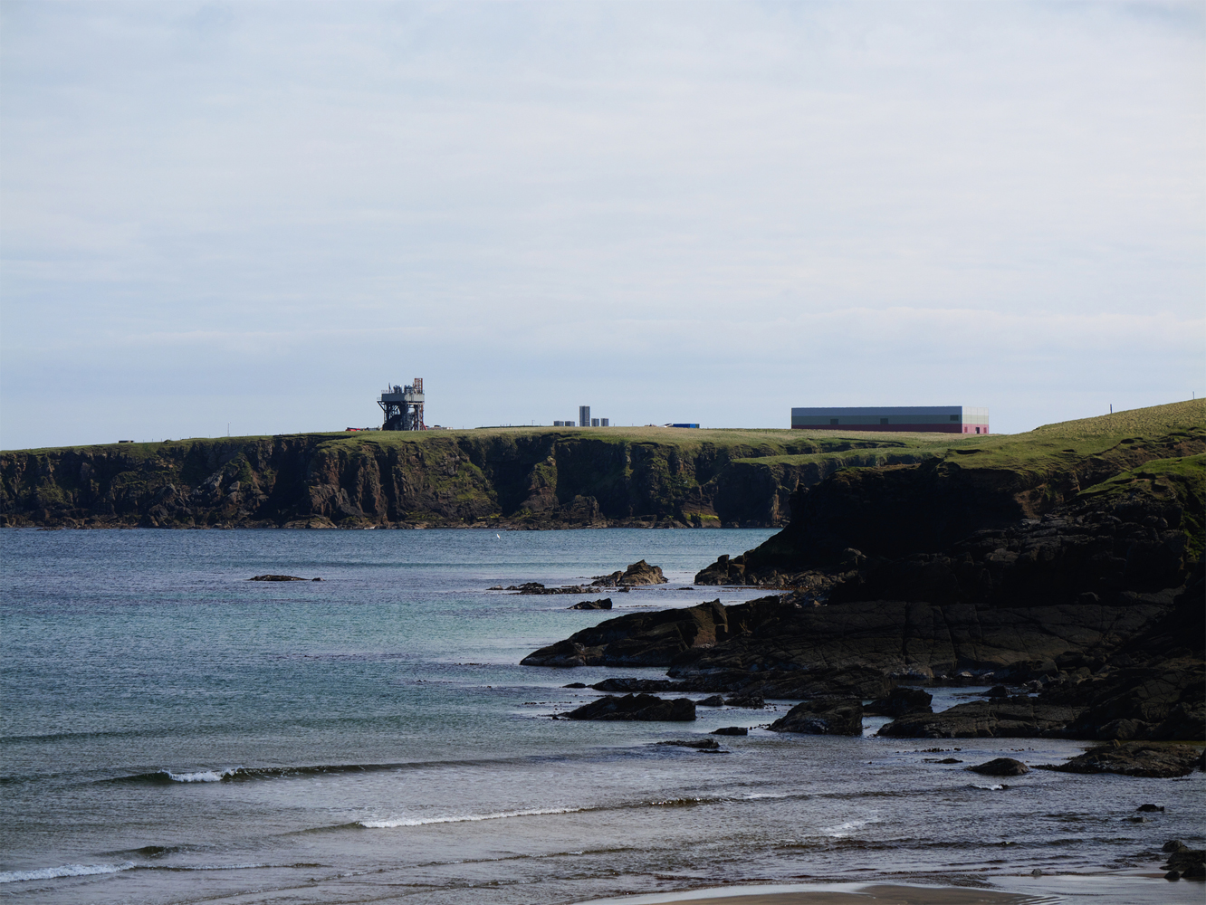 Aerial view of SaxaVord Spaceport launch facilities along the rugged coast of Unst, Shetland.