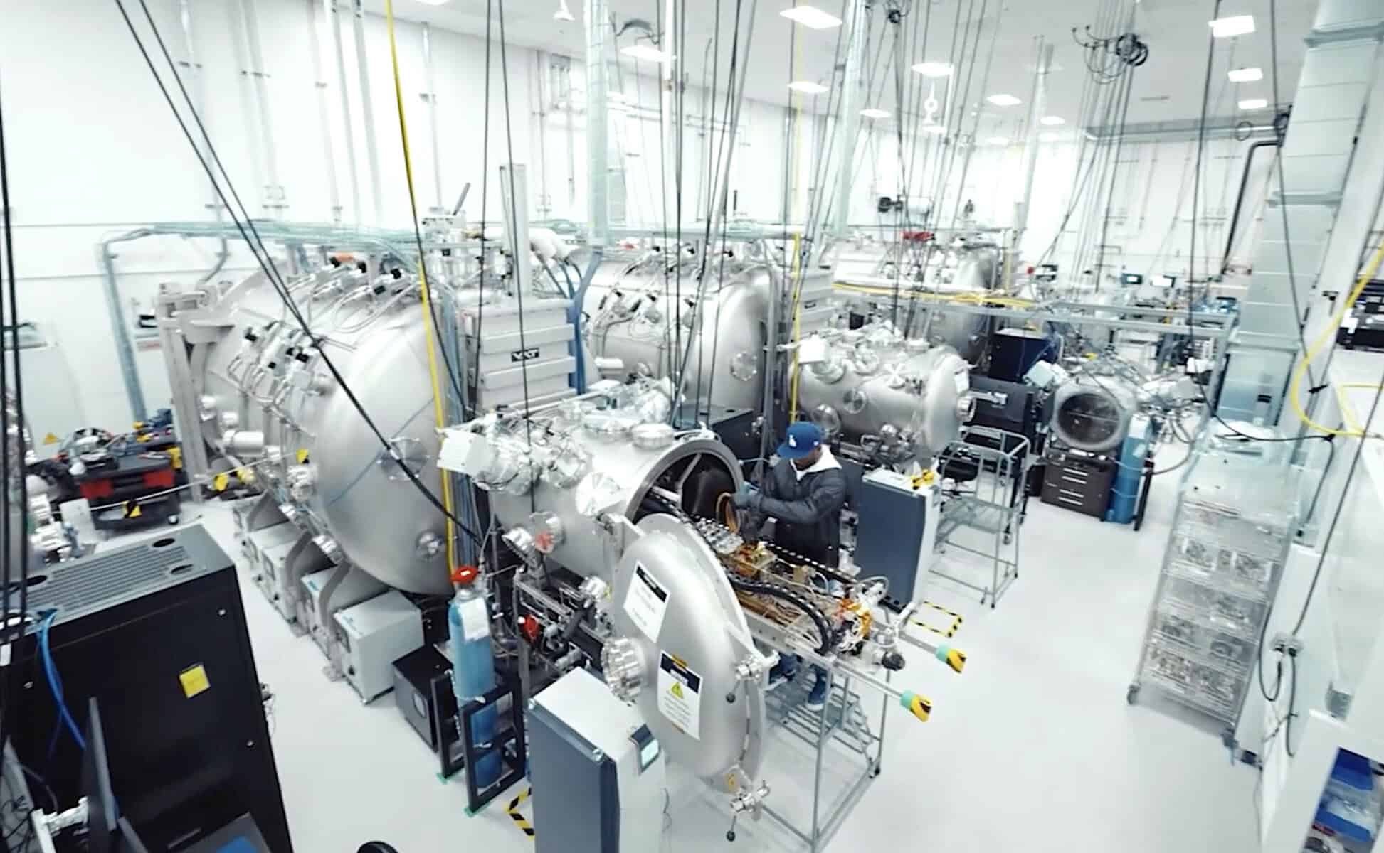 Technician working on satellite vacuum test chambers inside Amazon Leo's high-bay production facility in Kirkland, Washington.