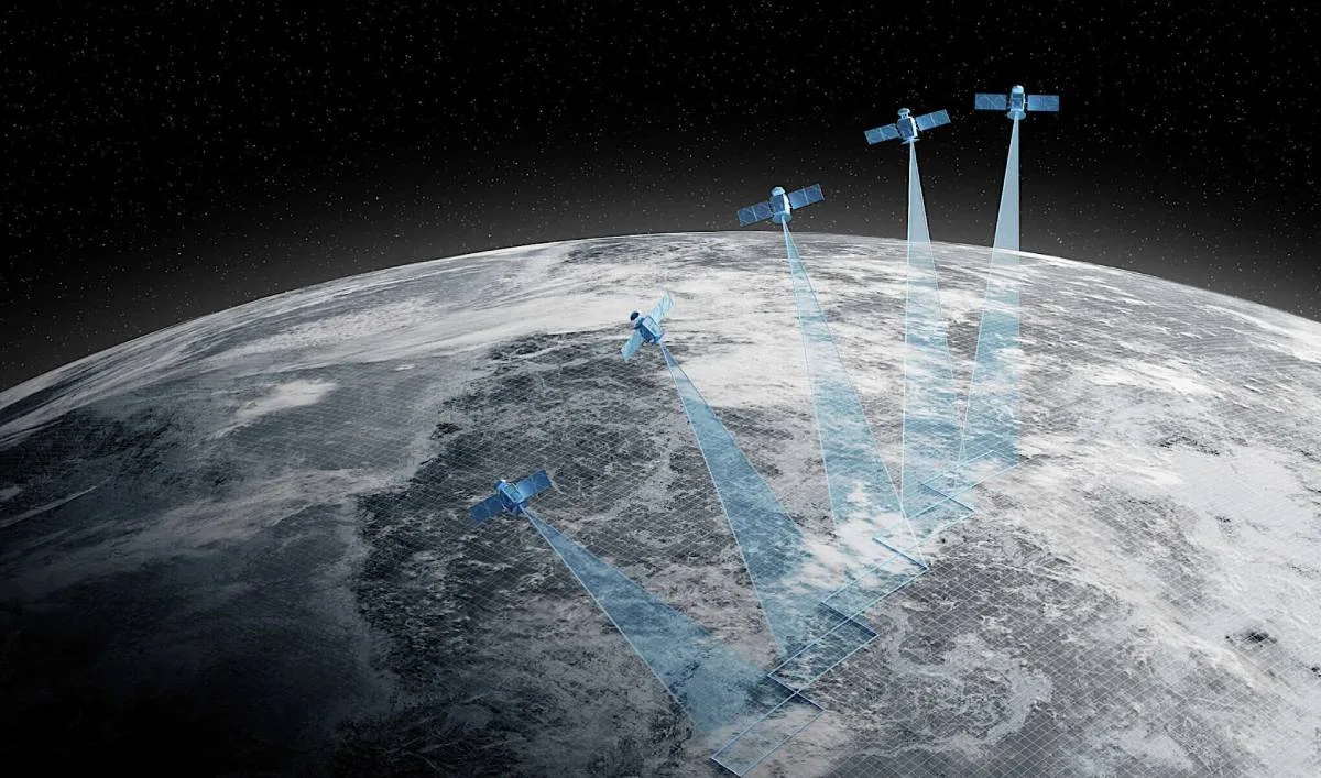 Digital illustration of Earth from space with five satellites orbiting overhead, each projecting blue beams that form a grid on the planet's surface to represent coordinated Earth-observation data collection.