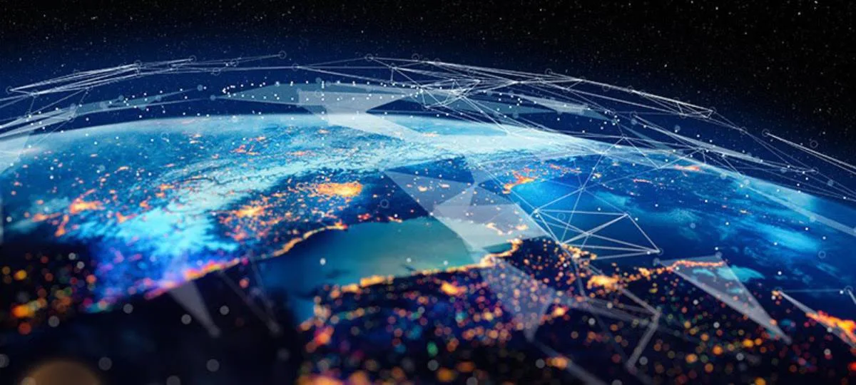 Digitally enhanced view of Earth from space showing illuminated population centers with an overlay of interconnected lines and nodes representing global satellite and data networks.