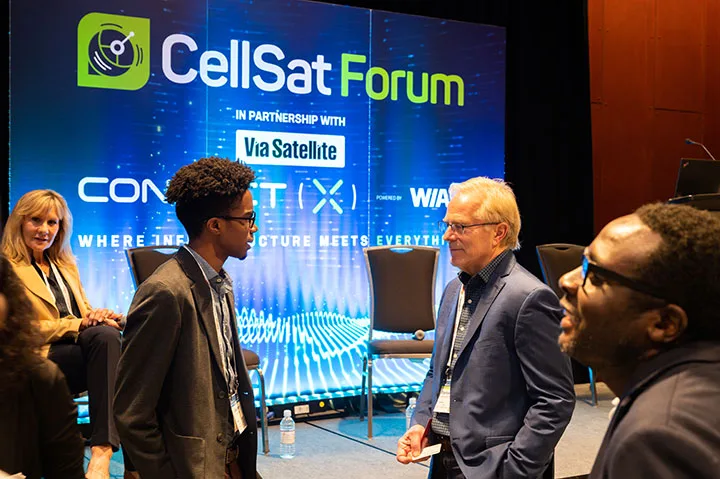 Speakers and attendees gather following a panel discussion at the Connect (X) CellSat Forum, hosted by the WIA on May 8, 2023, in New Orleans.